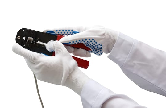 hand with gloves keeps wire cable crimper