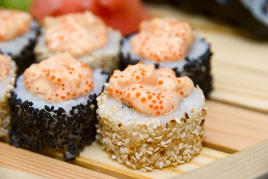 Close-up of of sushi on wood plate.