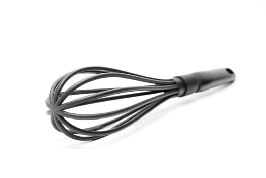 Black plastick kitchen whisk isolated on white background