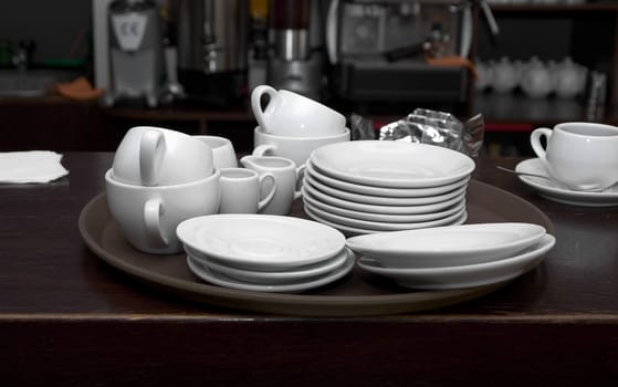 At cafeteria: set of tableware on bar counter