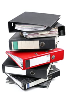 A stack of black files with an important red one.