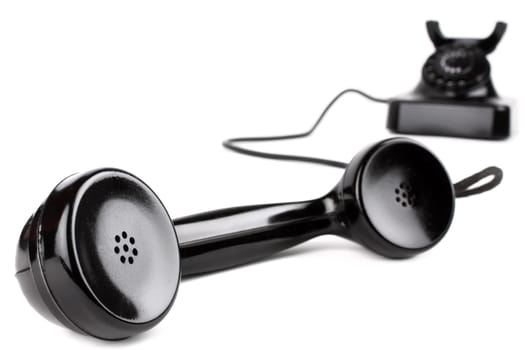 Handset in the foreground of an old telephone.