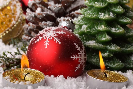 Christmas time still life with snow,crescents,fir branches,Christmas tree baubles and pine cones.