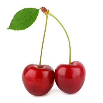 A few fresh cherries with stem and leaf.