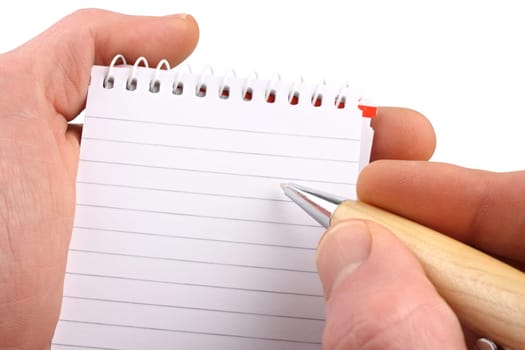 Notepad with pen on white background