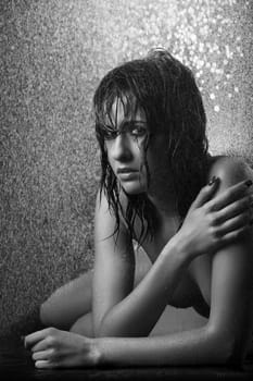 intimate image of a sexy young woman under the rain