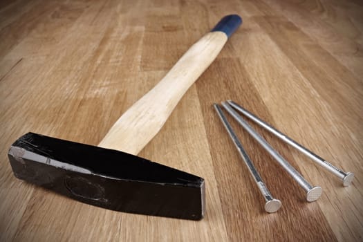 Hammer with three nails on countertop