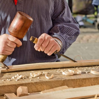 The woodcarver work in the workshop. Work of artist.