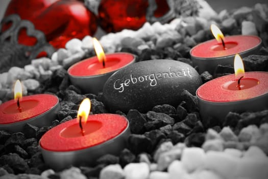 Still life with heart,inscribed stone and candle.