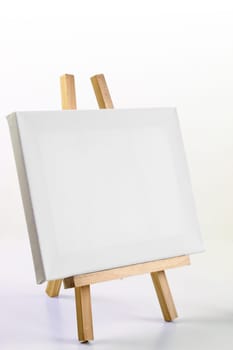 Easel with blank canvas and copy space