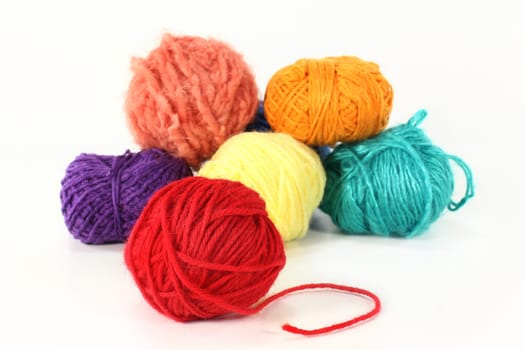 Colorful ball of wool against white background