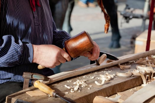 The woodcarver work in the workshop. Work of artist.