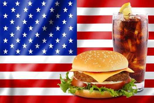 Cheeseburger and cola in front of the American flag.