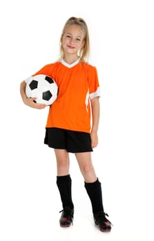 Nine year old girl holding soccer ball isolated on white.