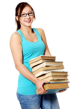 Young caucasian pretty girl smiling and holding many books. Isolated on white.