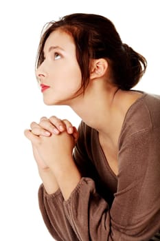 Young caucasian girl praying and looking up.