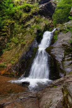 Shot of the fall of water. Stream Huntava - natural area - nature preserve. Resov, Czech republic, Europe.