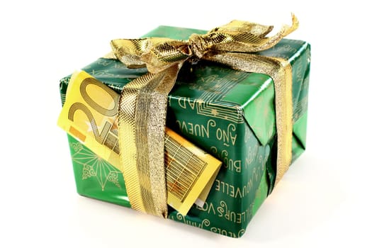 Christmas gift with euro bill against white background