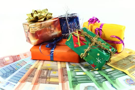 Christmas gifts and euro bills against white background