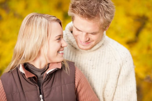 Autumn smiling young couple in love hugging in park together