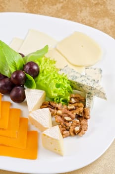 cheese with lettuce, grapes and nuts closeup