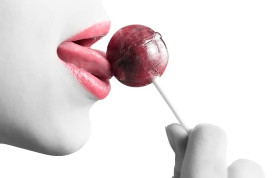 Woman licking lollipop closeup isolated on white.