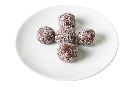 Chocolate ball cakes at plate isolated on white background