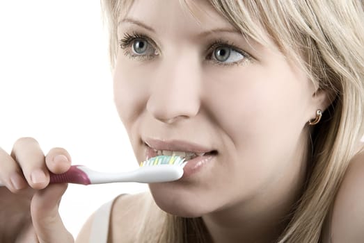 Young beautiful woman clean her teeth