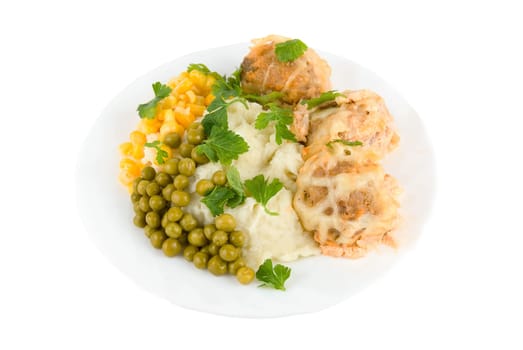 Healthy restaurant food: meatballs, potatoes, verdure, peas and corn on white