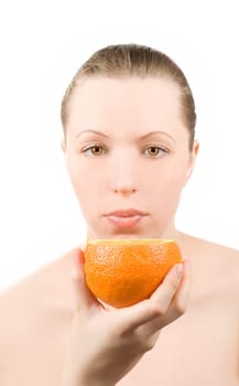 Pretty girl with orange fruit on white