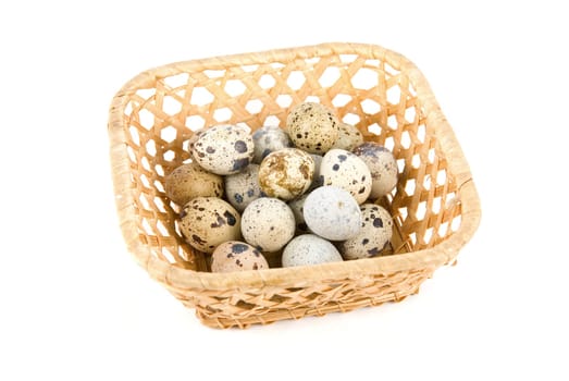 quail eggs in the basket on white