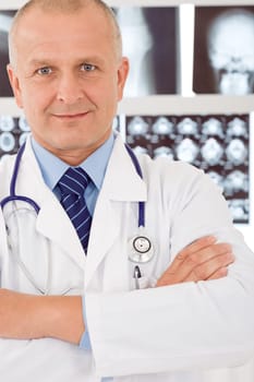Portrait of male doctor standing at front of set x-ray
