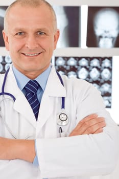 Portrait of male doctor standing at front of set x-ray