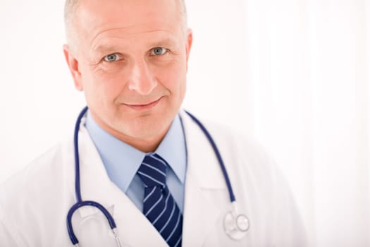 Portrait of mature professional doctor male with stethoscope crossed arms