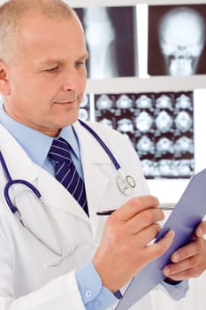 Portrait of professional male doctor hold and look aside x-ray