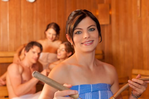 Four friends in the sauna of a thermal bath