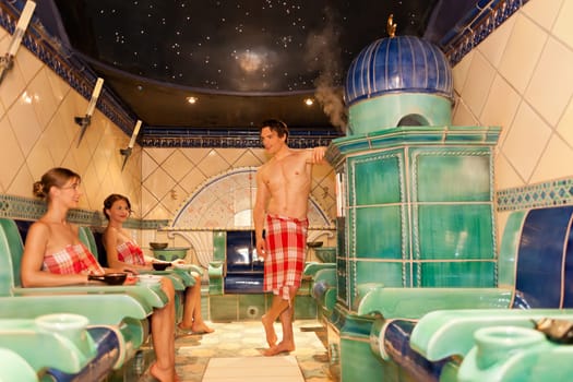 Three friends in the sauna of a thermal bath