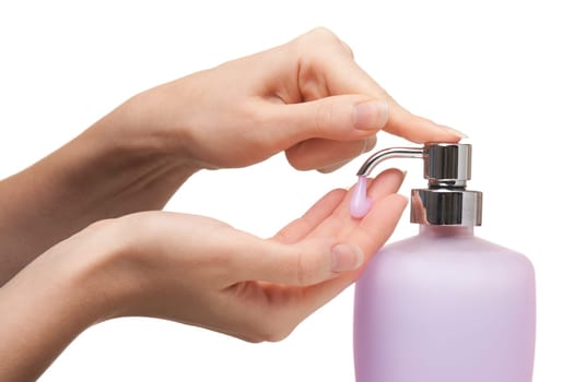 Woman washing her hands with pink liquid soap. White background.