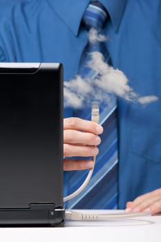 Cloud computing concept. Man send data from laptop to cloud via ethernet cable. Selective focused on cable.
