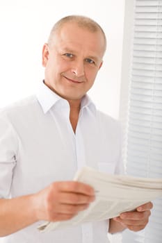 Happy senior businessman professional portrait read newspapers white shirt