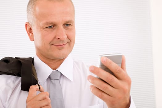 Mature handsome businessman wear suit looking at phone close-up portrait