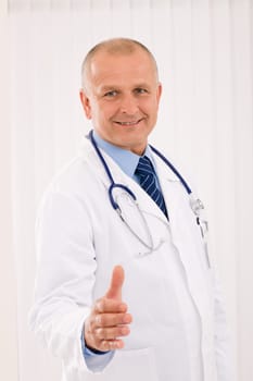 Happy mature doctor male giving handshake welcoming portrait