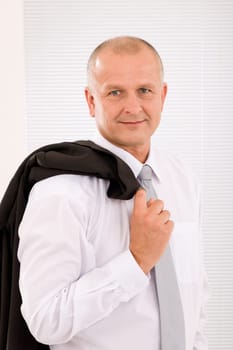 Successful mature businessman professional portrait jacket over shoulder