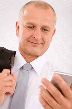Mature handsome businessman wear suit looking at phone close-up portrait