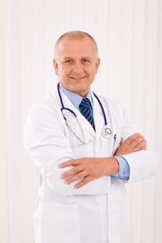 Portrait of mature professional doctor male with stethoscope crossed arms