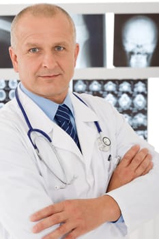 Portrait of male doctor standing at front of set x-ray
