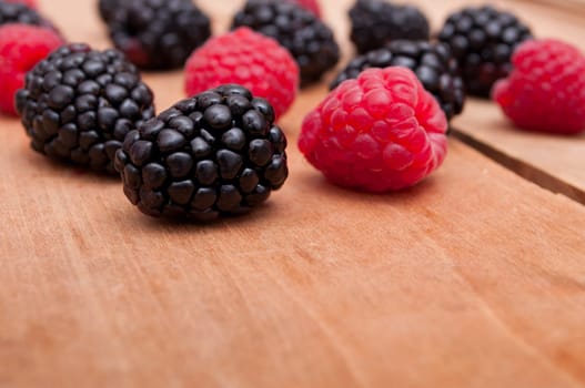 Raspberries and Blackberries on Old Wooden Table - Shallow Depth of Field