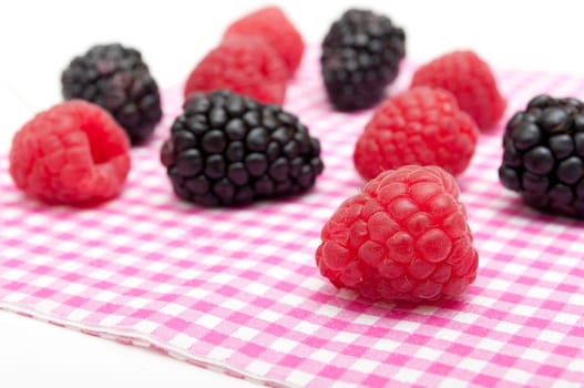 Raspberries and Blackberries on Table on White Background