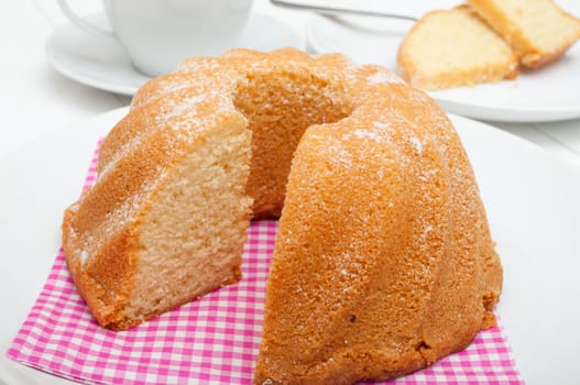 Guglhupf - Traditional Sponge Cake on Plate and Cup on Table