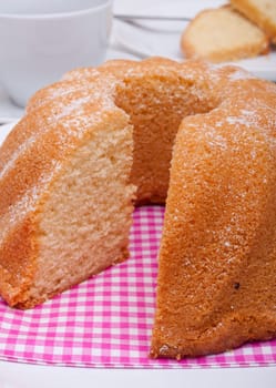 Guglhupf - Traditional Sponge Cake on Plate and Cup on Table